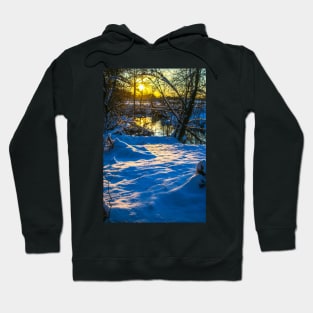 Snow falling on a river with snowy banks Hoodie